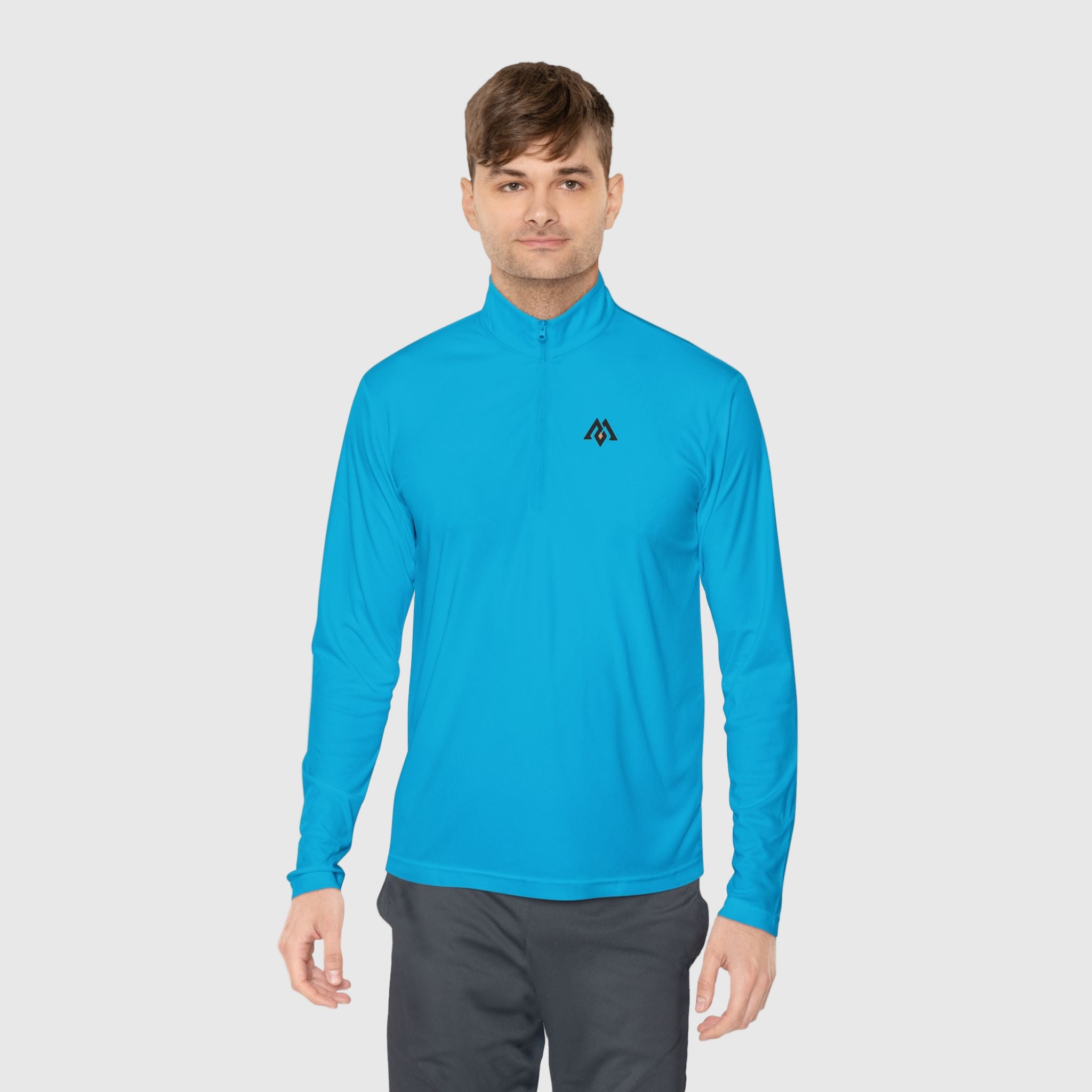 Man wearing a blue long-sleeve athletic shirt with a logo on a white background