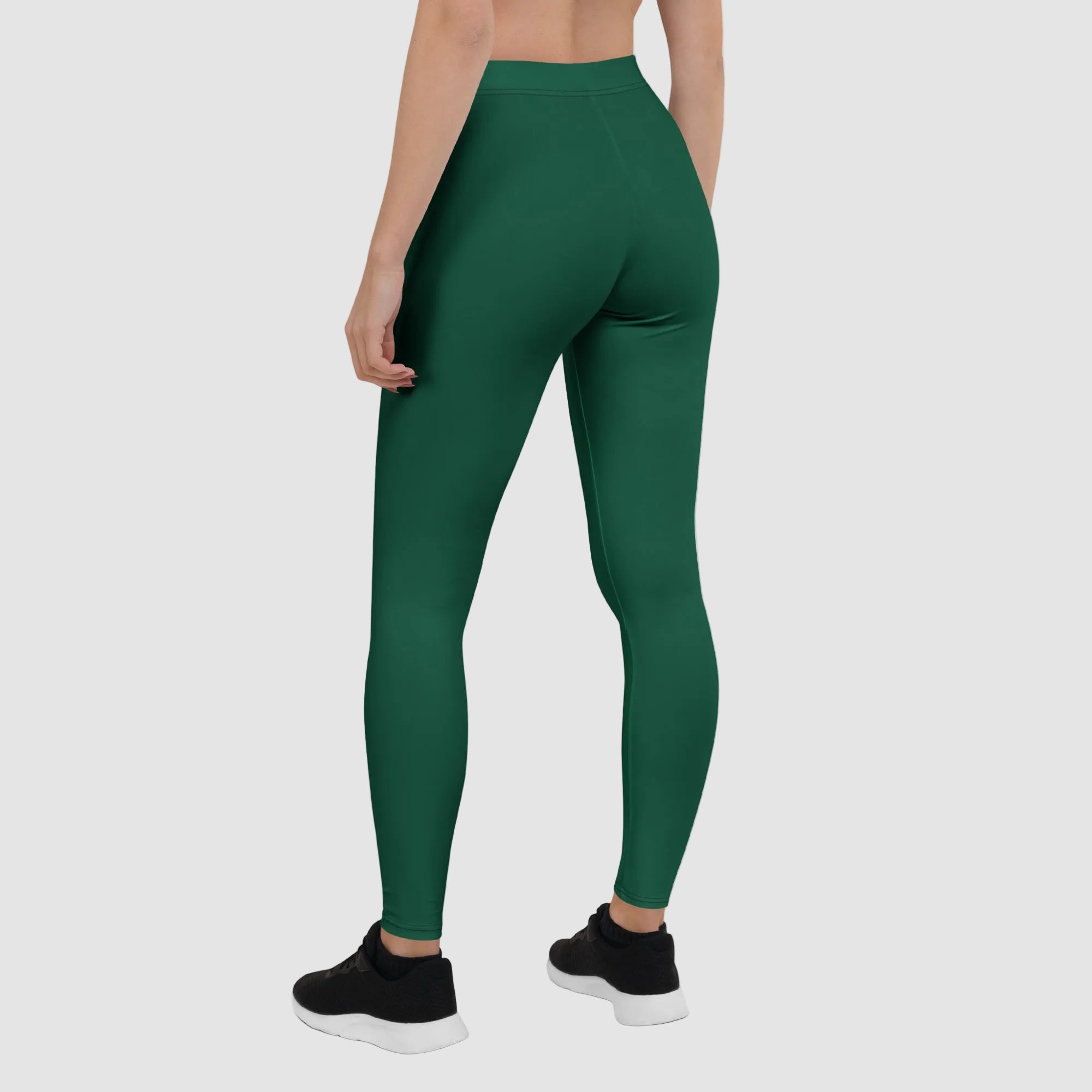 Green leggings worn by a person on a white background