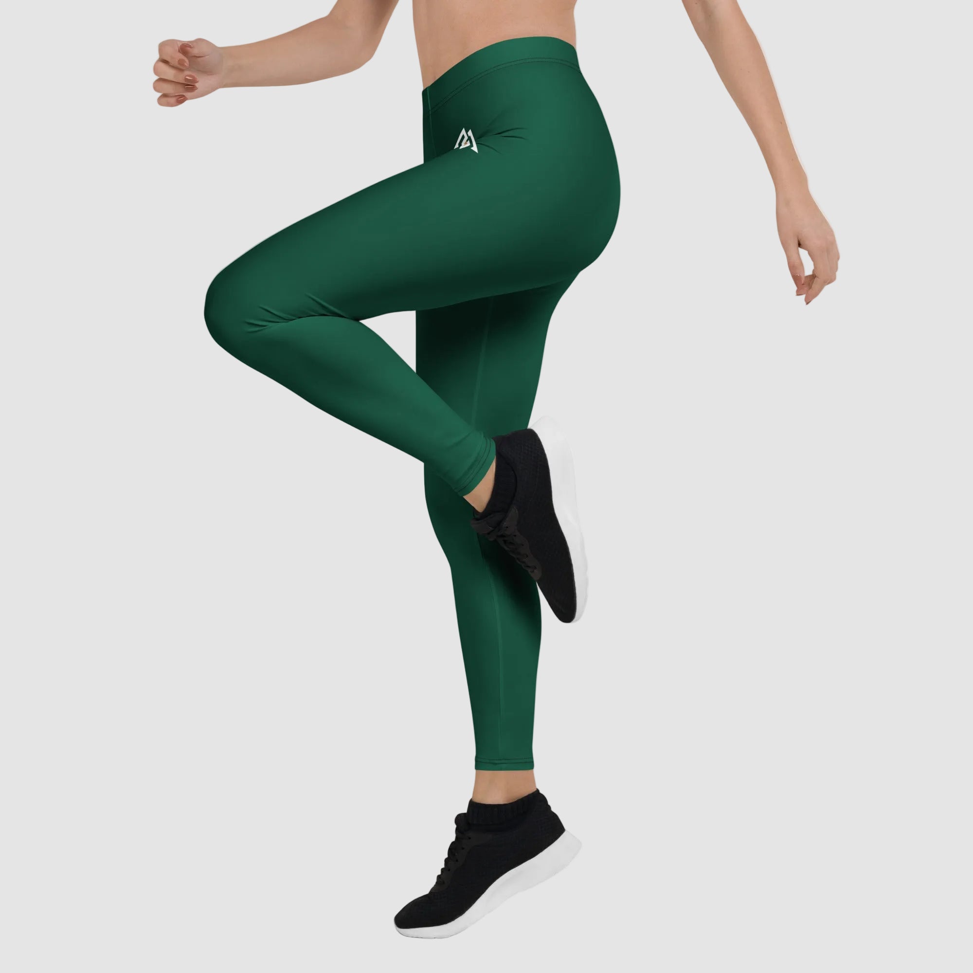 Green leggings worn by a person on a white background