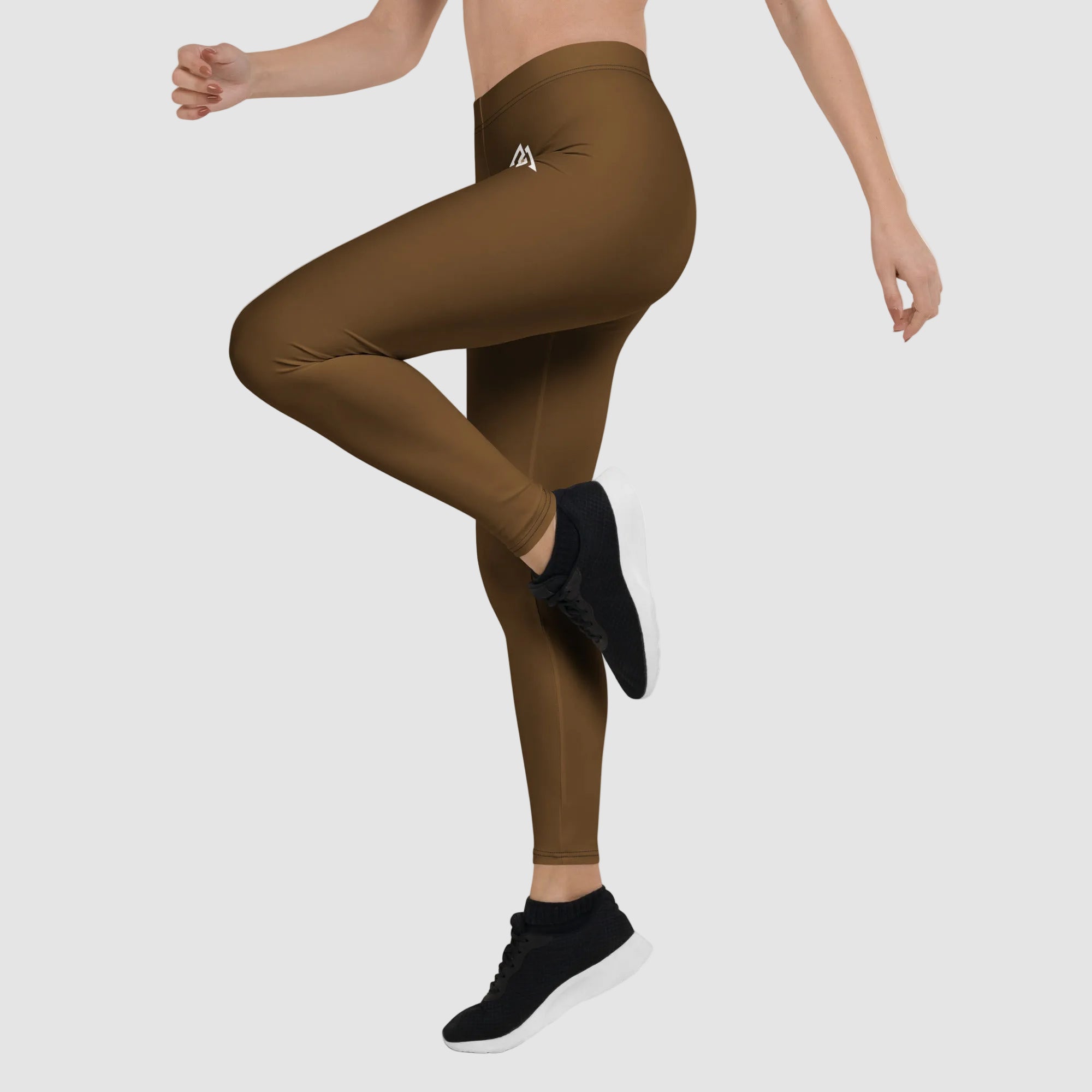 Brown leggings worn by a person on a white background