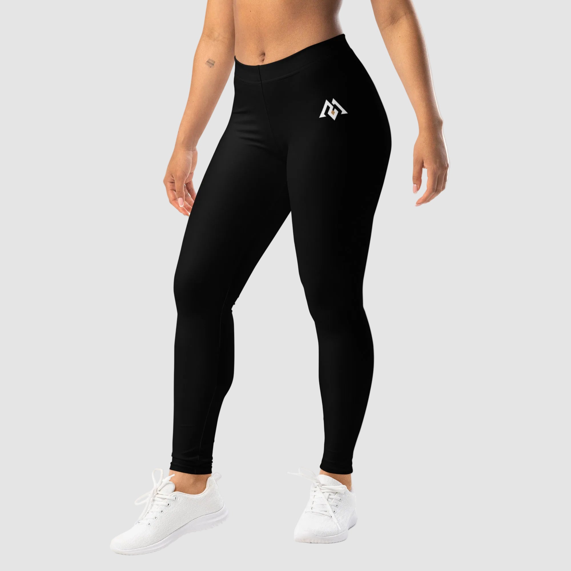 Person wearing black leggings with a logo on a white background