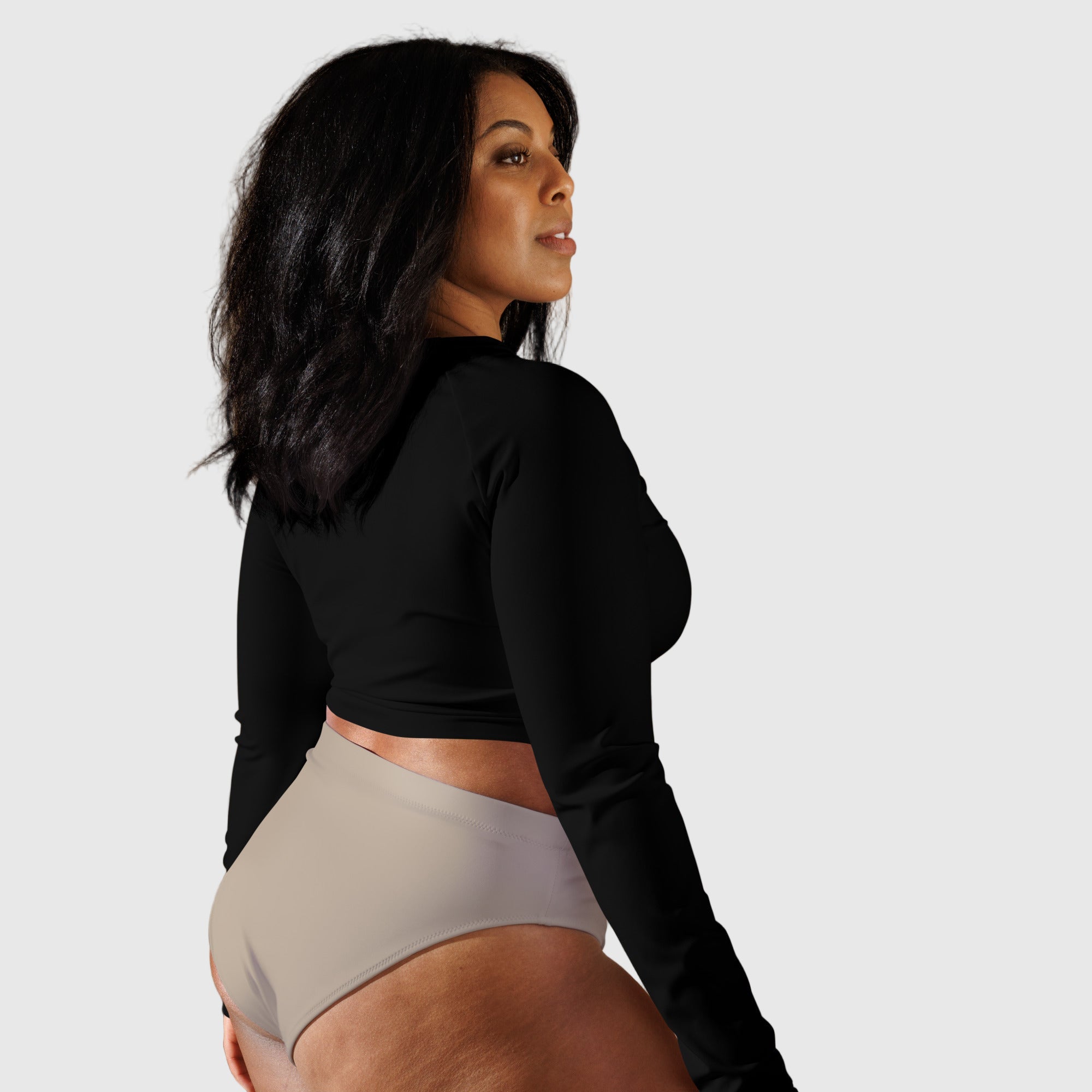 Active Aegis Recycled Long-Sleeve Crop Top in black, made from recycled polyester with sleek, breathable compression fit — ideal for gym, yoga, and sustainable everyday wear.
