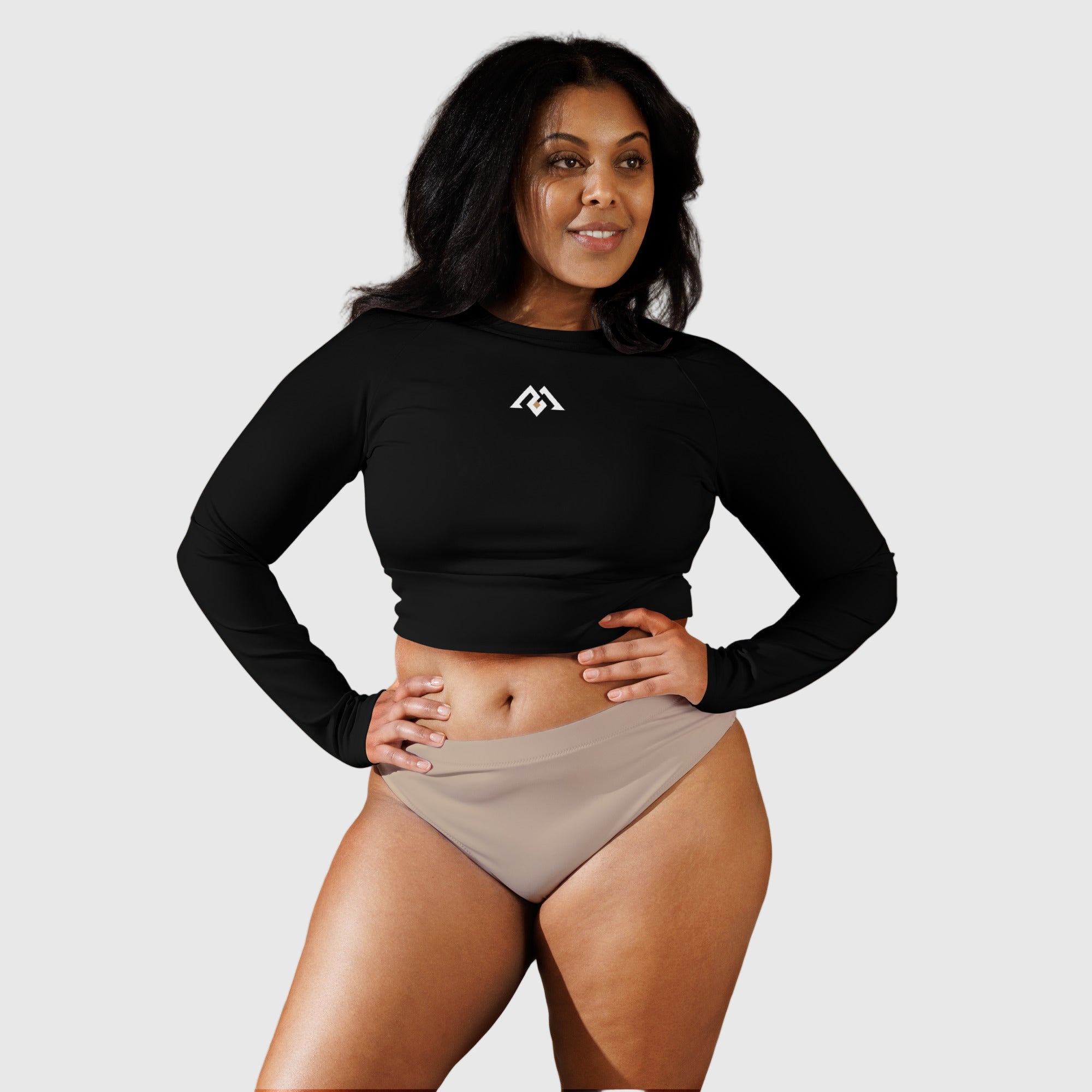 Active Aegis Recycled Long-Sleeve Crop Top in black, made from recycled polyester with sleek, breathable compression fit — ideal for gym, yoga, and sustainable everyday wear.