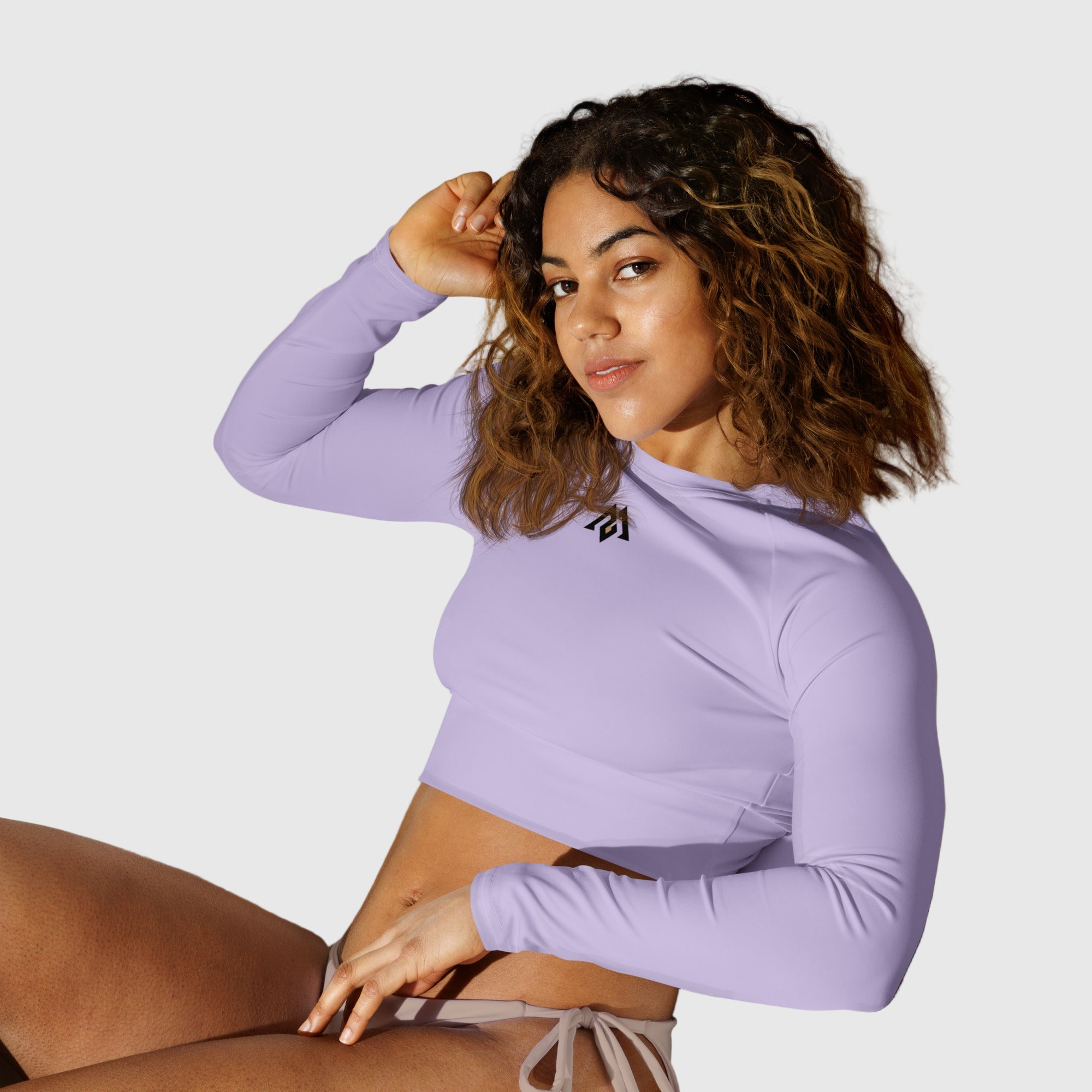 Active Aegis Recycled Long-Sleeve Crop Top in black, made from recycled polyester with sleek, breathable compression fit — ideal for gym, yoga, and sustainable everyday wear.