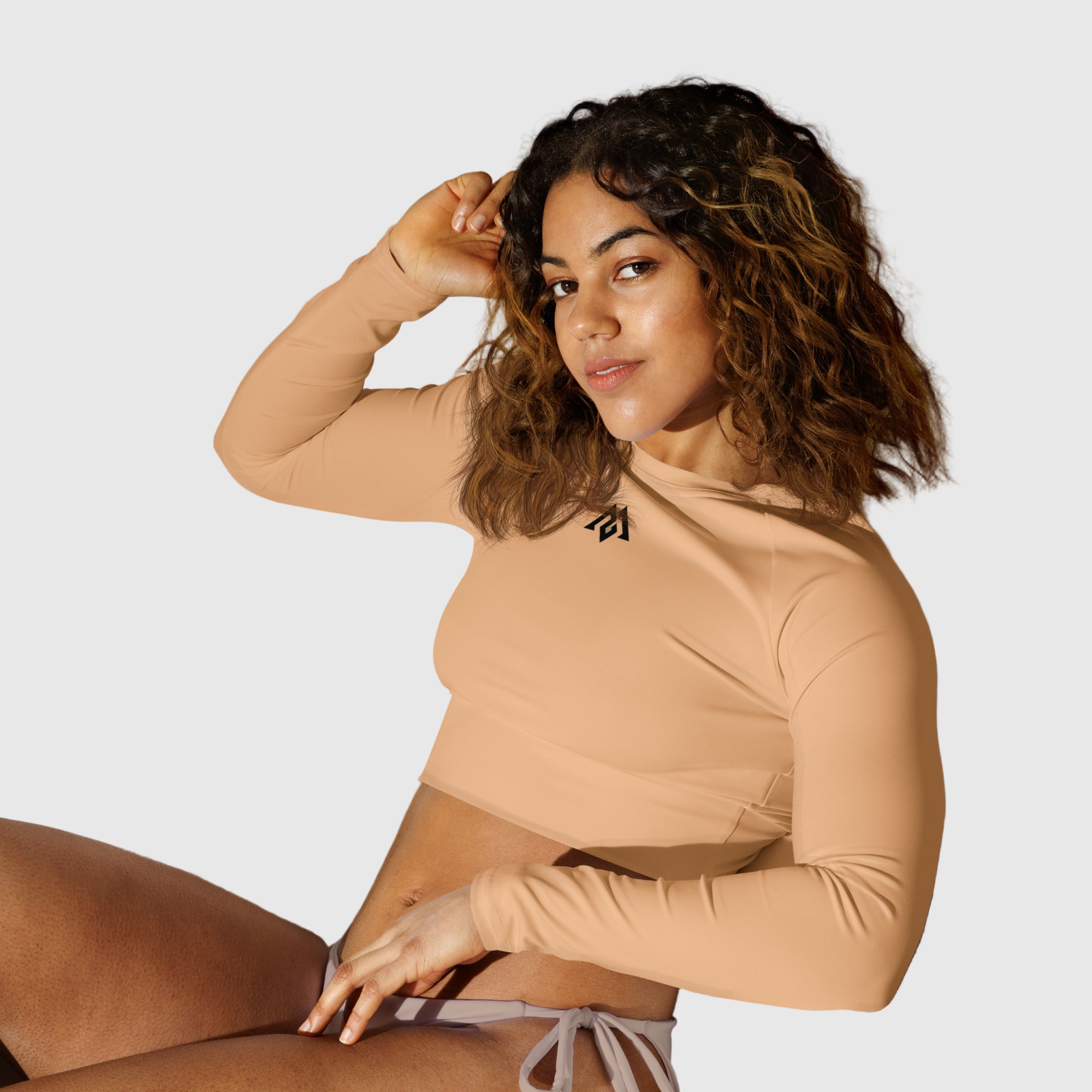 Active Aegis Recycled Long-Sleeve Crop Top in black, made from recycled polyester with sleek, breathable compression fit — ideal for gym, yoga, and sustainable everyday wear.
