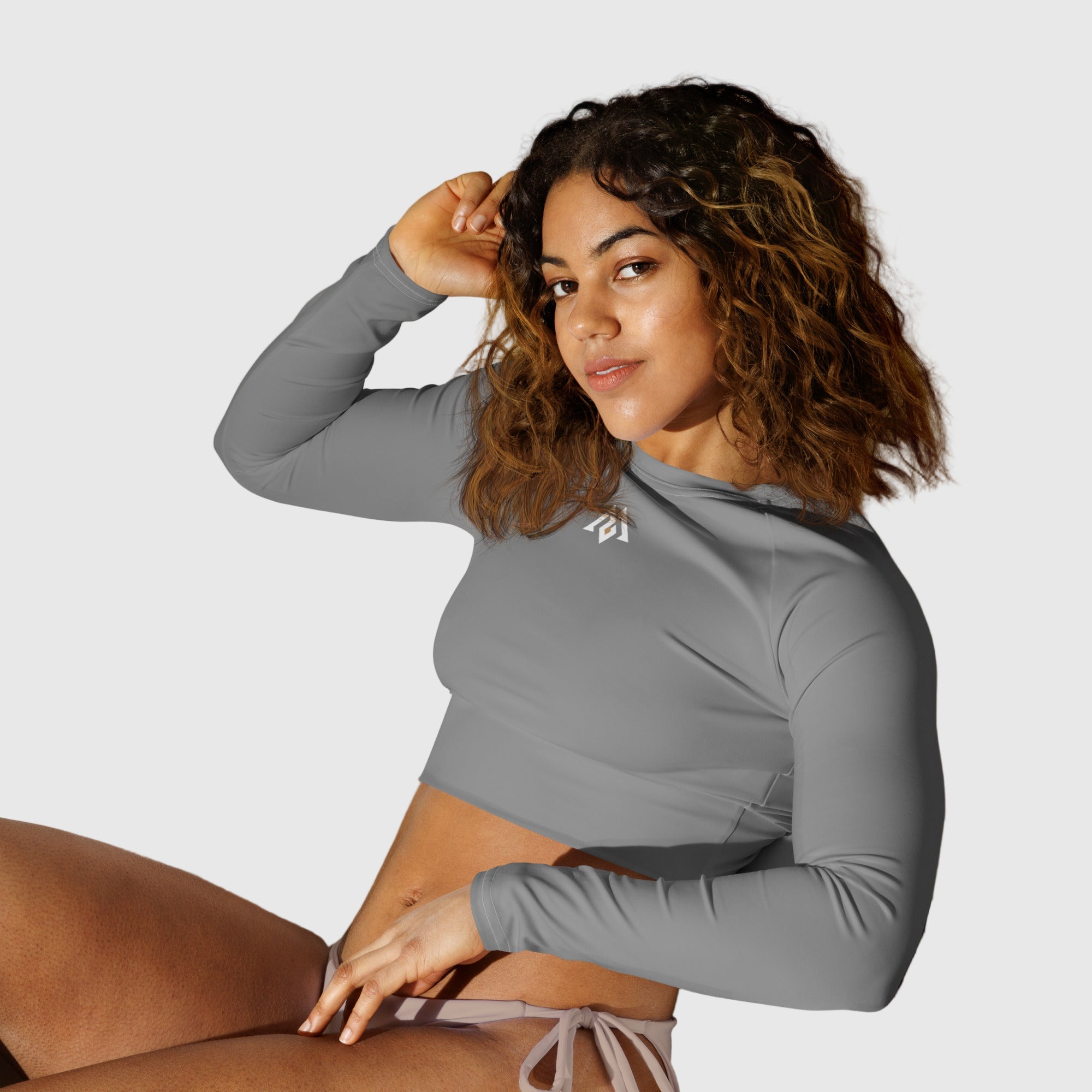 Active Aegis Recycled Long-Sleeve Crop Top in black, made from recycled polyester with sleek, breathable compression fit — ideal for gym, yoga, and sustainable everyday wear.