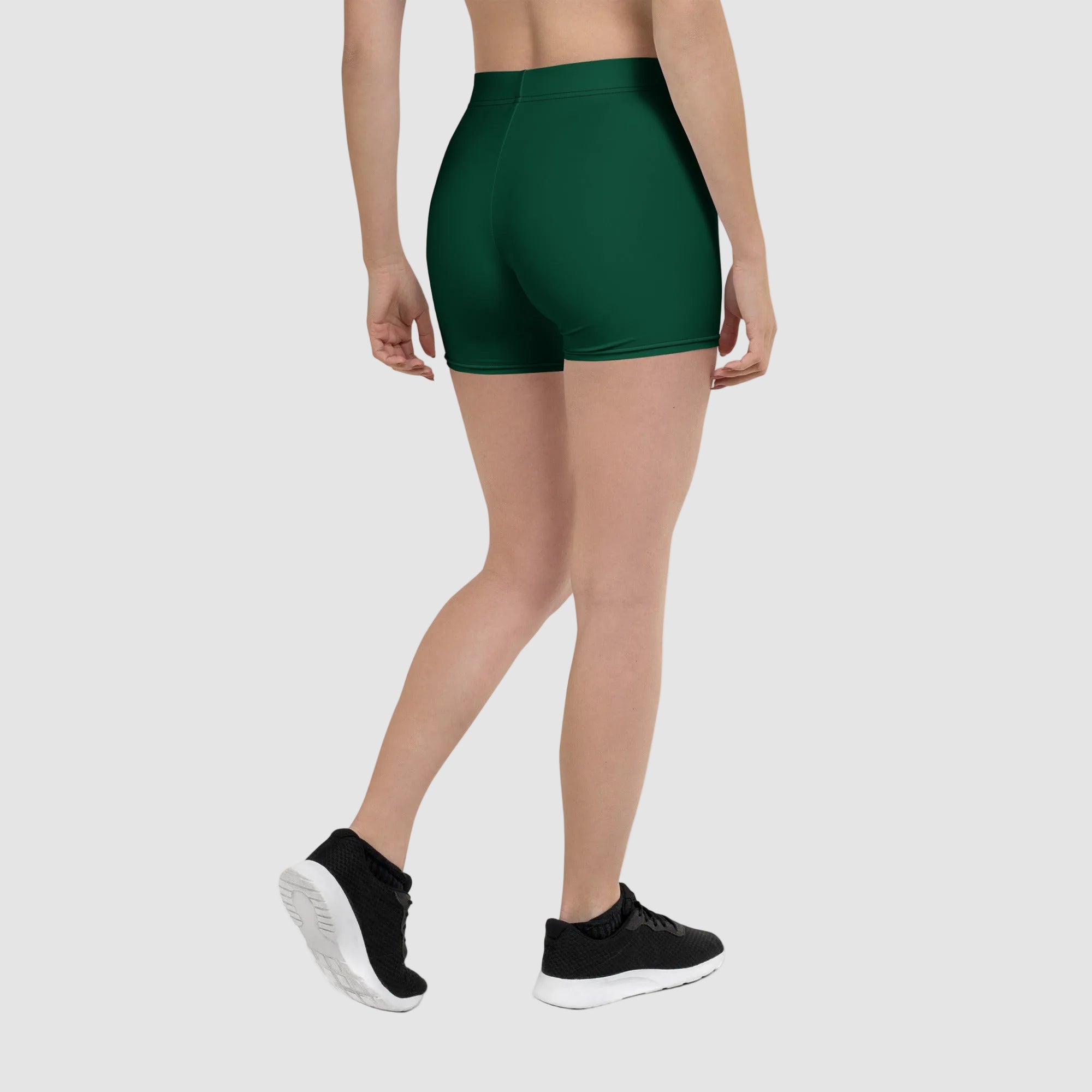 Person wearing green athletic shorts on a white background