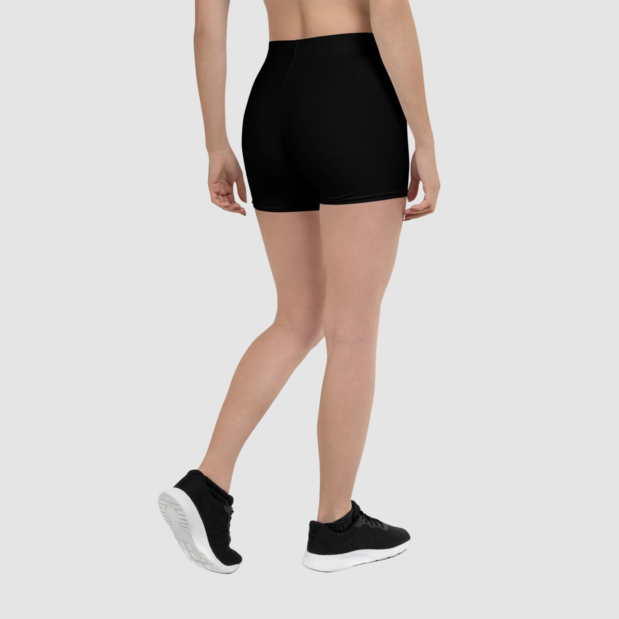 Person wearing a black athletic skirt on a white background