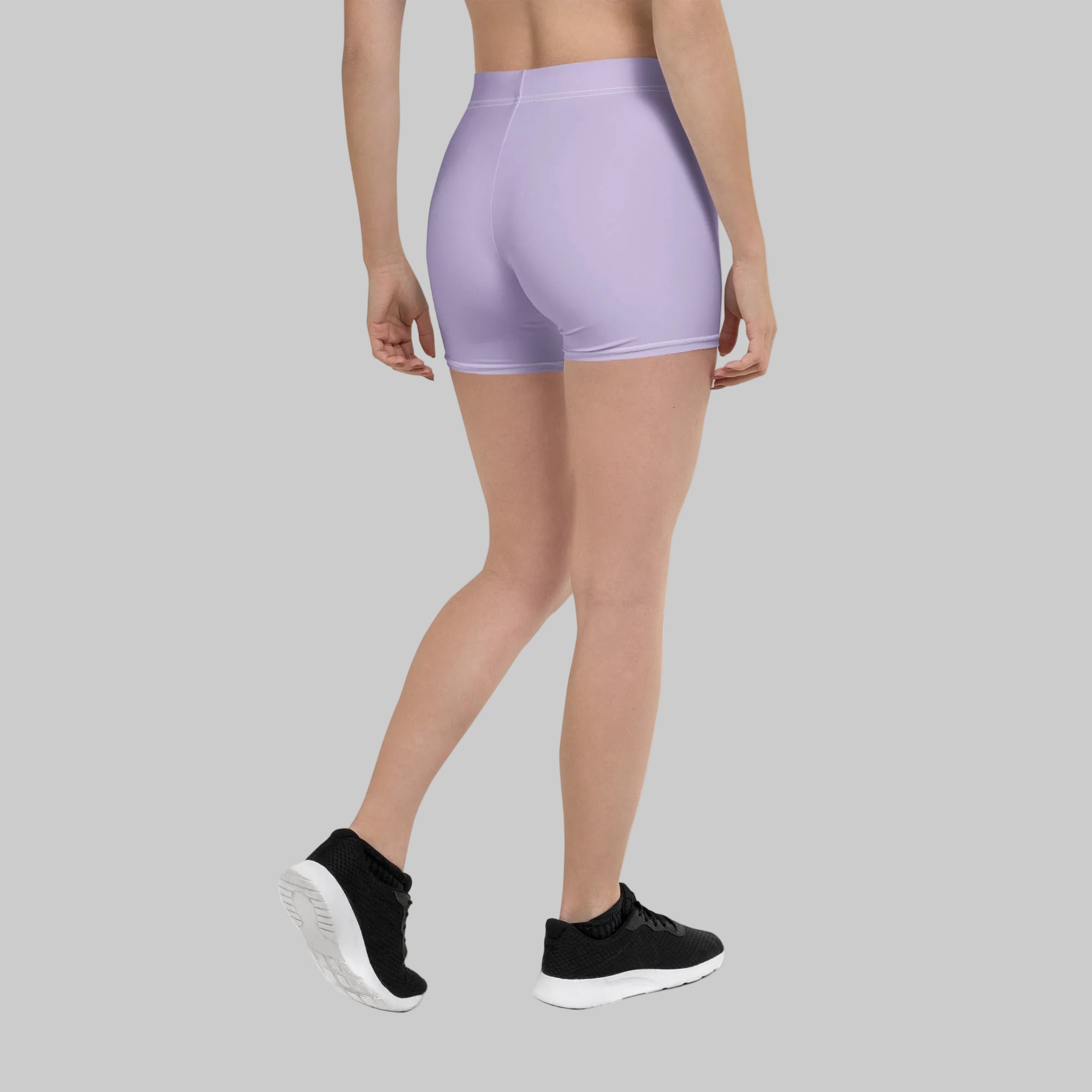 Person wearing light purple athletic shorts on a white background