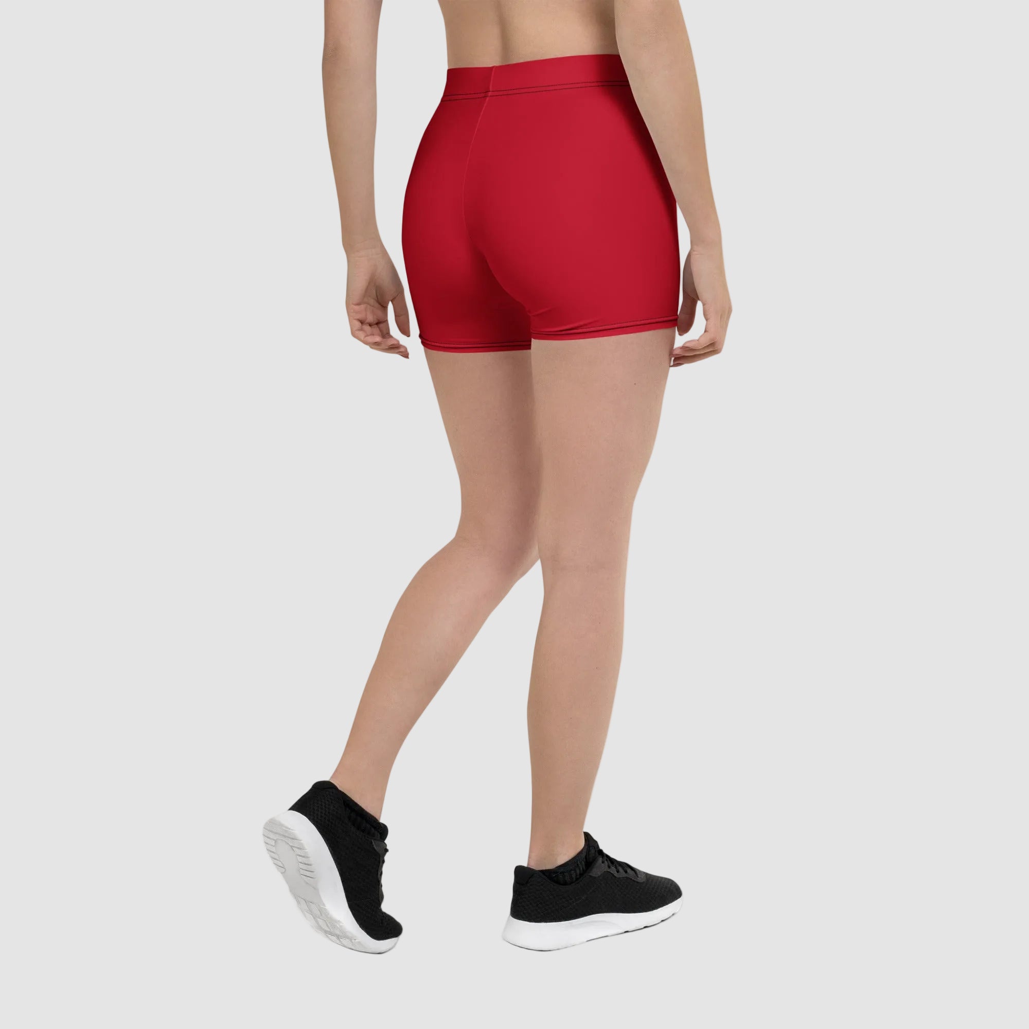 Person wearing red athletic shorts on a white background