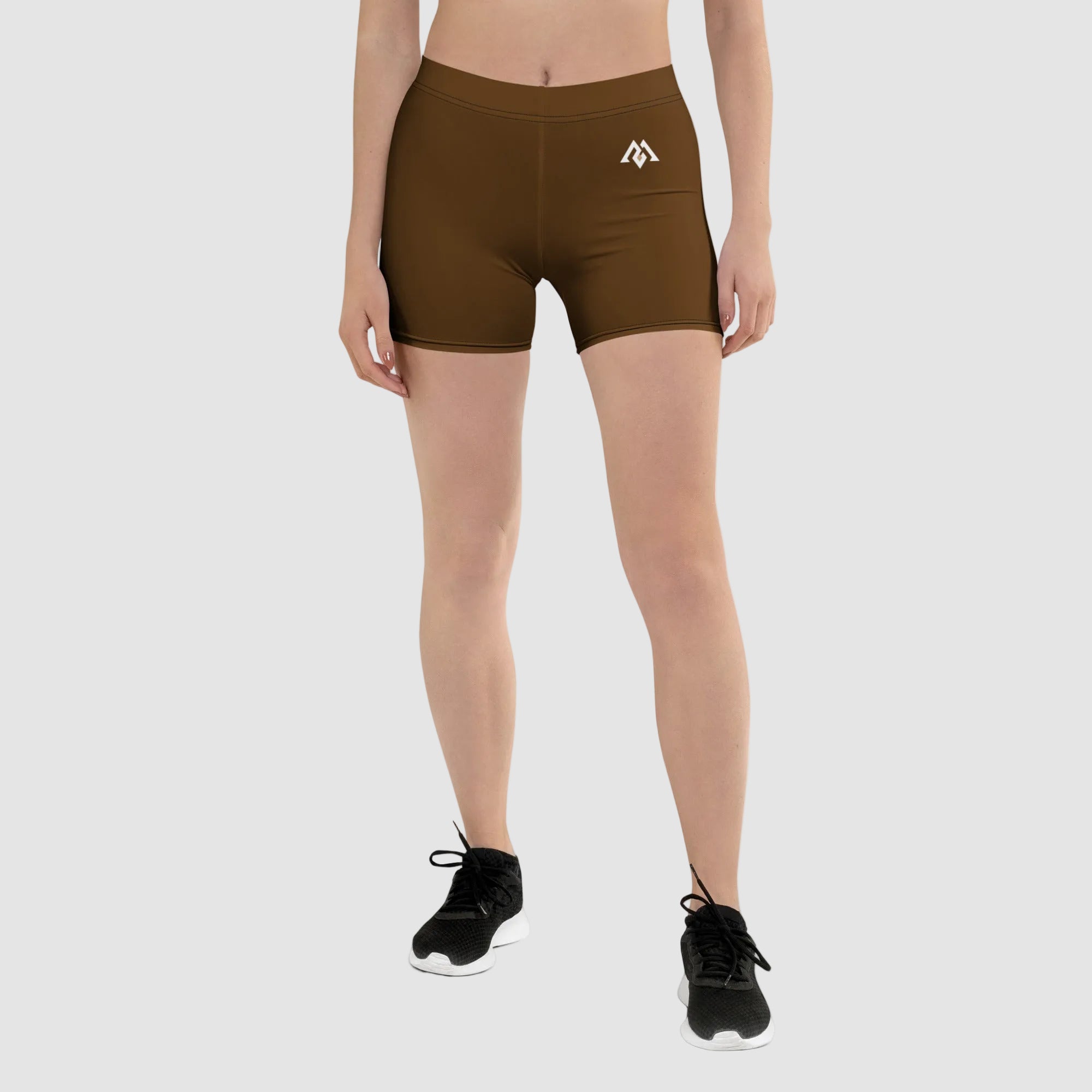 Person wearing brown athletic shorts with a logo on a white background