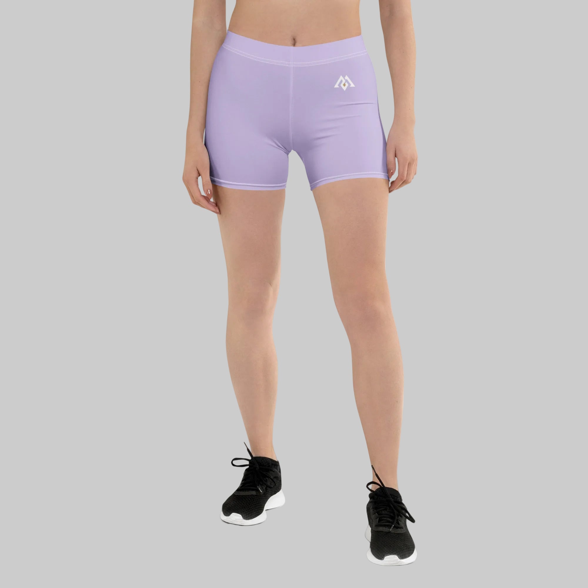 Person wearing light purple athletic shorts with a logo on a white background