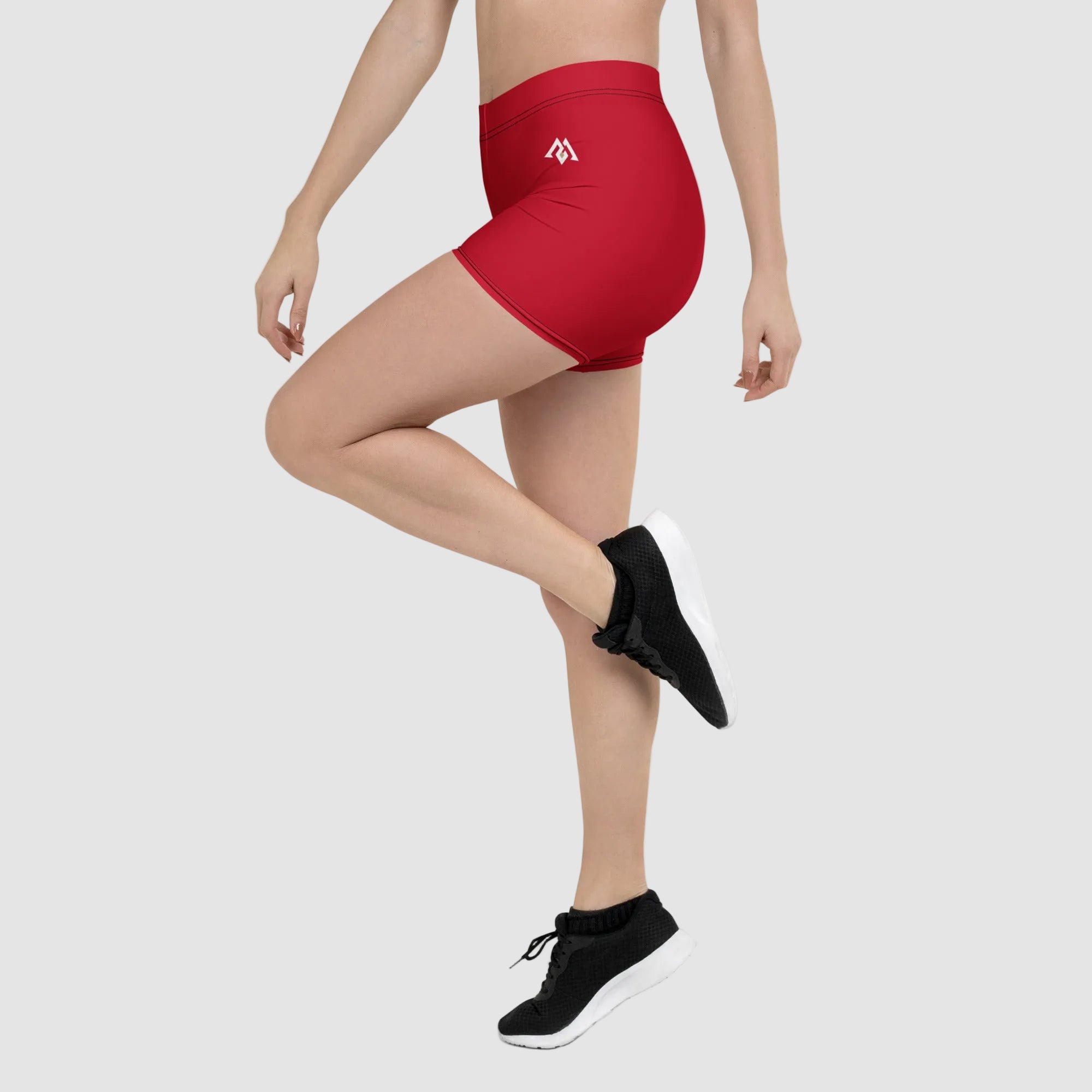 Red athletic shorts worn by a person on a white background