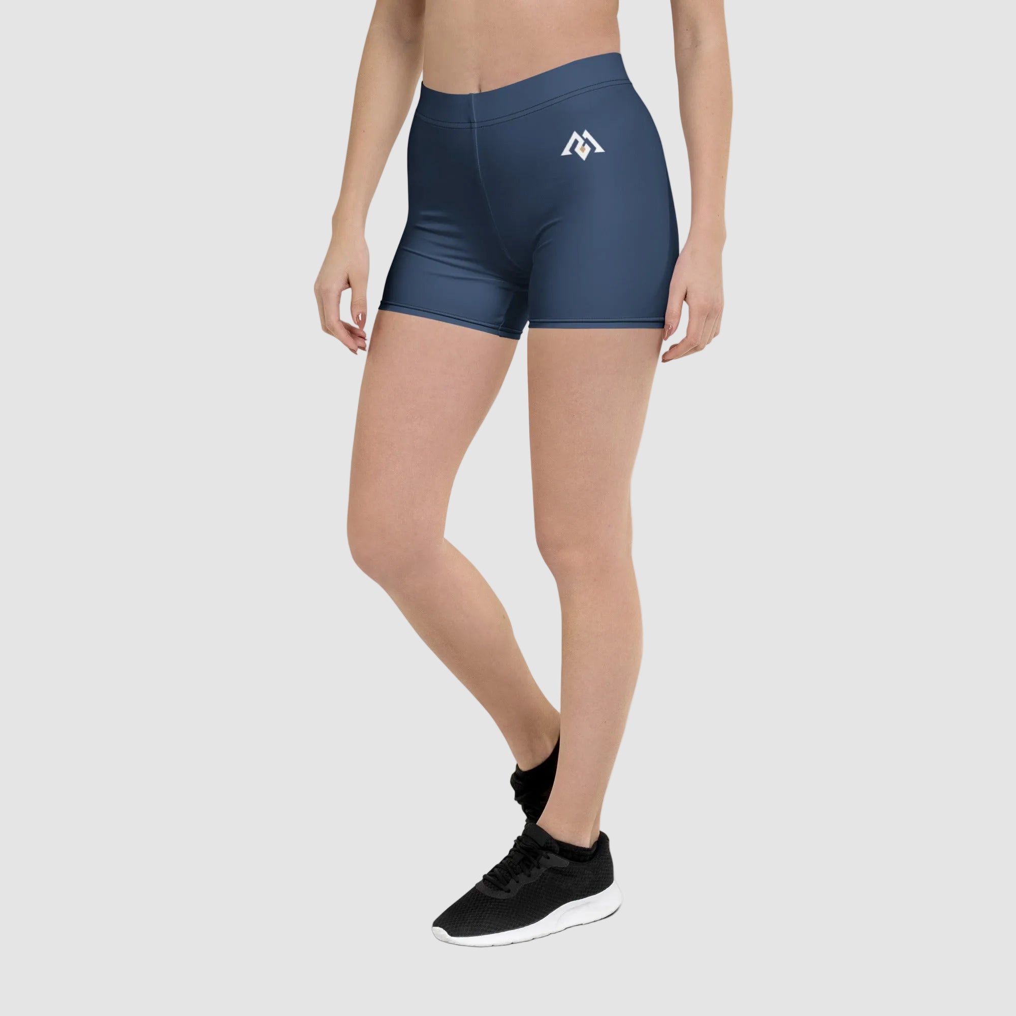 Person wearing blue athletic shorts with a logo on a white background