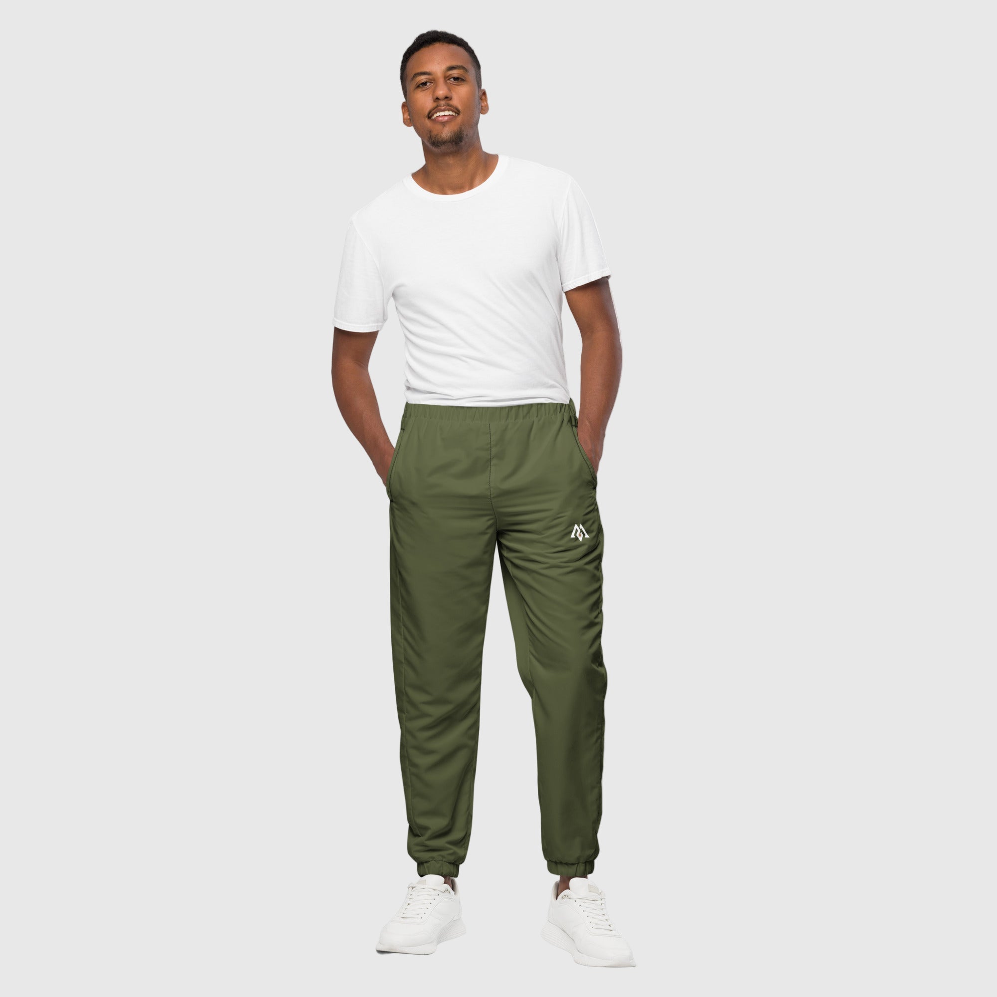 Model wearing ActiveAegis Unisex Track Pants in Saratoga Green – tapered, breathable, sustainable joggers made from recycled fabric for gym and casual wear.