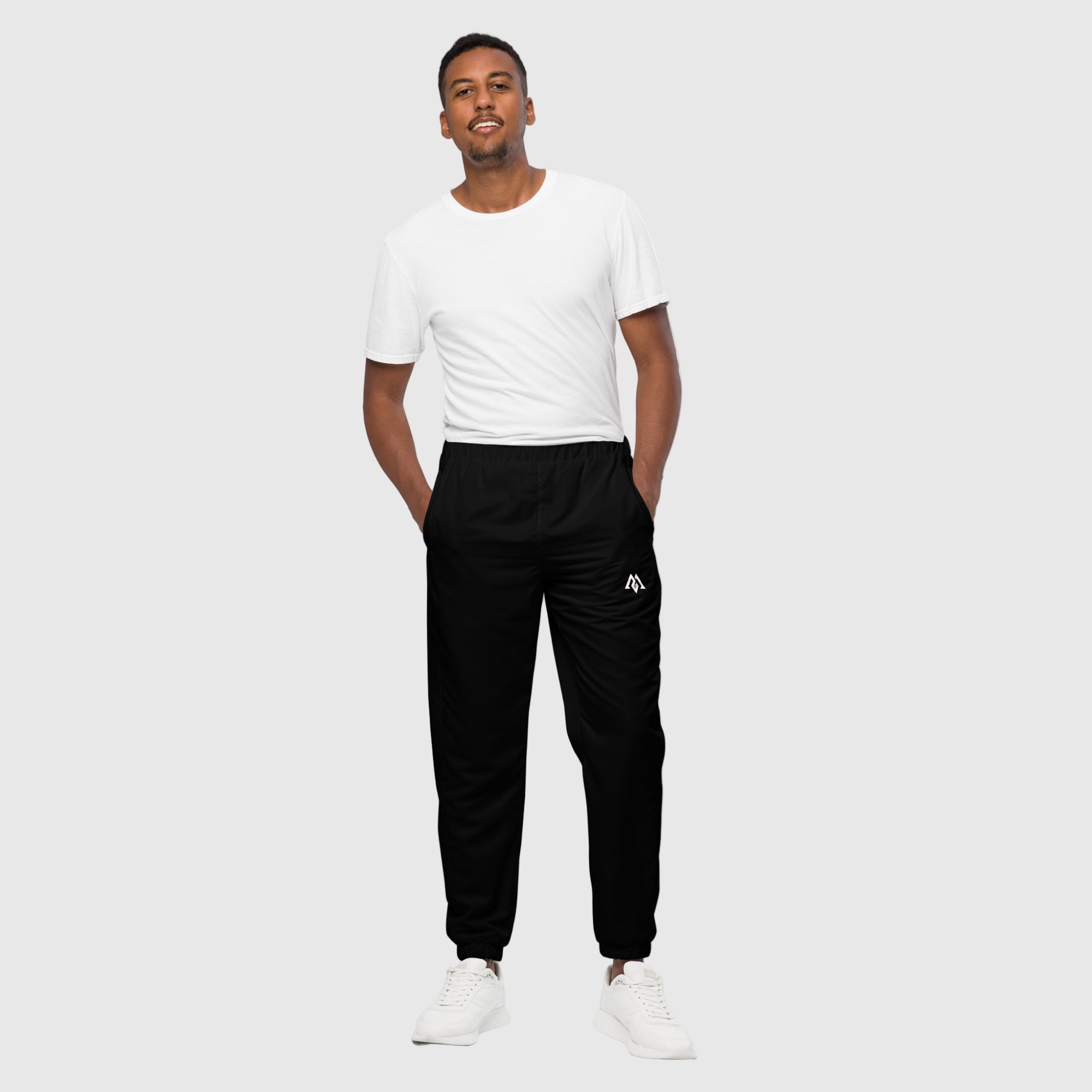 Model wearing ActiveAegis Unisex Track Pants in black – sustainable, breathable, tapered performance joggers for gym, street, and everyday wear.