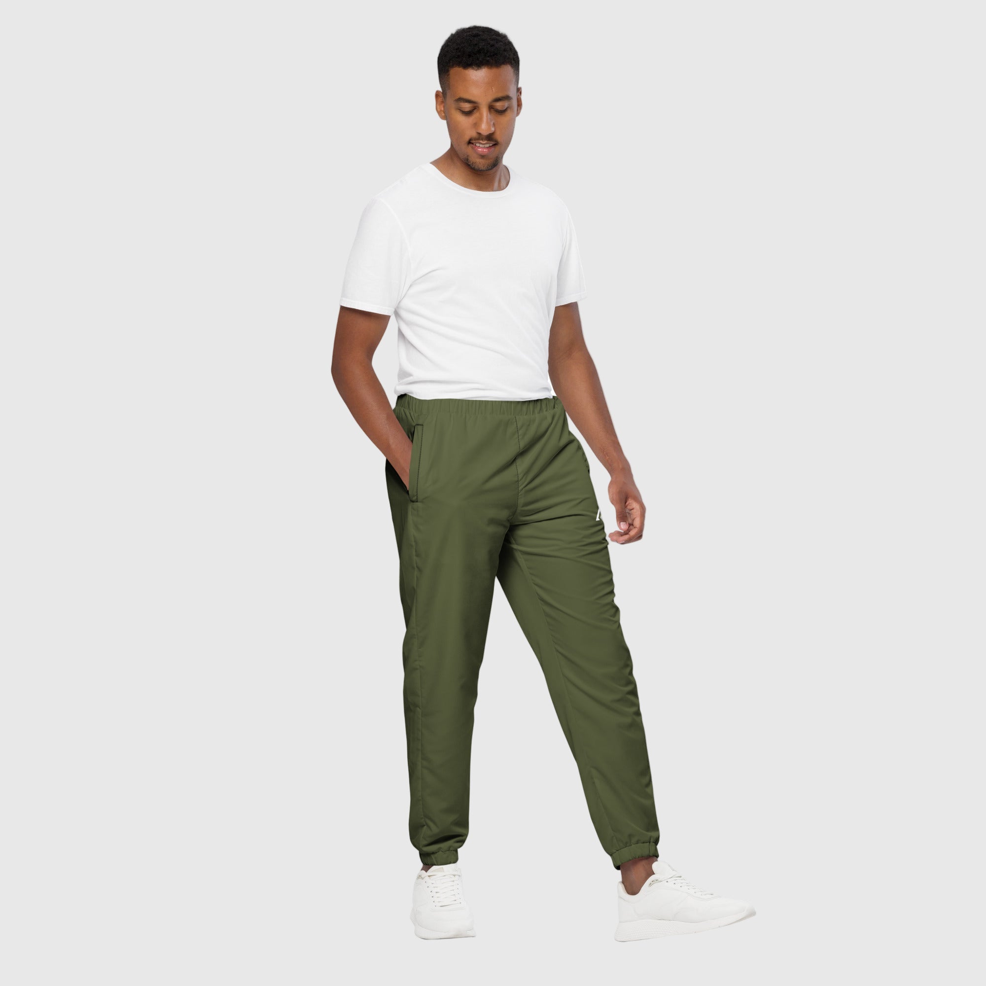 Model wearing ActiveAegis Unisex Track Pants in Saratoga Green – tapered, breathable, sustainable joggers made from recycled fabric for gym and casual wear.