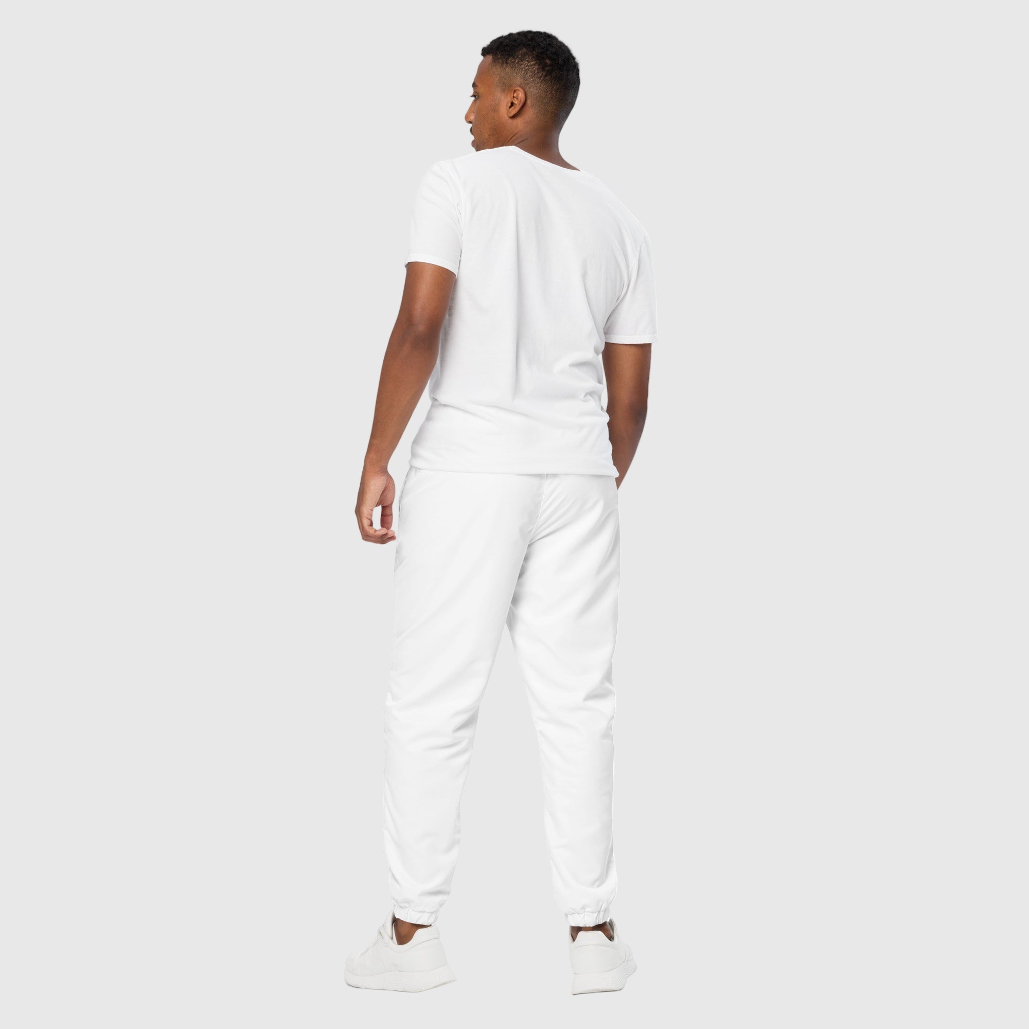 Model wearing ActiveAegis Unisex Track Pants in black – lightweight, tapered, and breathable activewear for gym and casual use