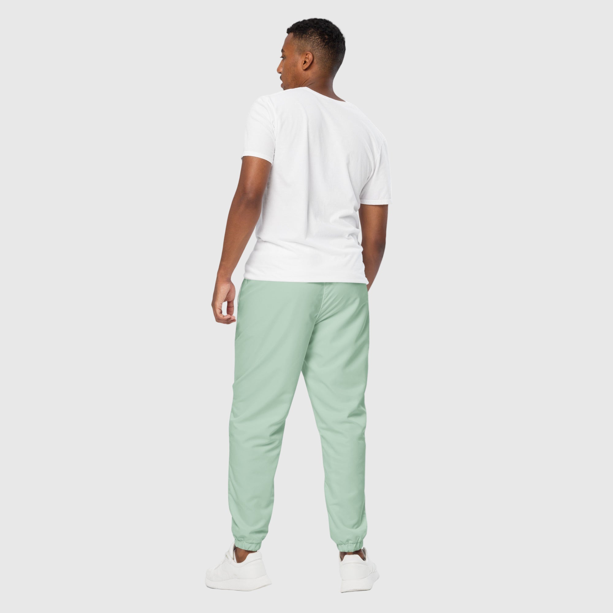 Model wearing ActiveAegis Unisex Track Pants in Edgewater Blue – lightweight, breathable, and stretch-fit eco-friendly performance joggers