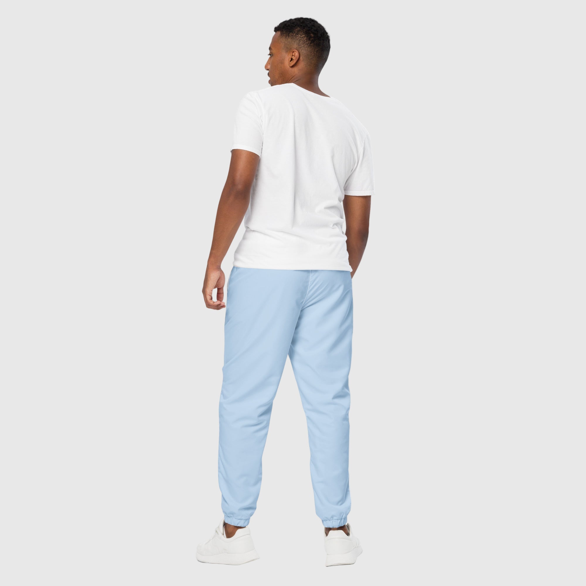 Model wearing ActiveAegis Unisex Track Pants in Pattens Blue – eco-friendly, stretch-fit, and breathable tapered joggers for gym and lifestyle comfort