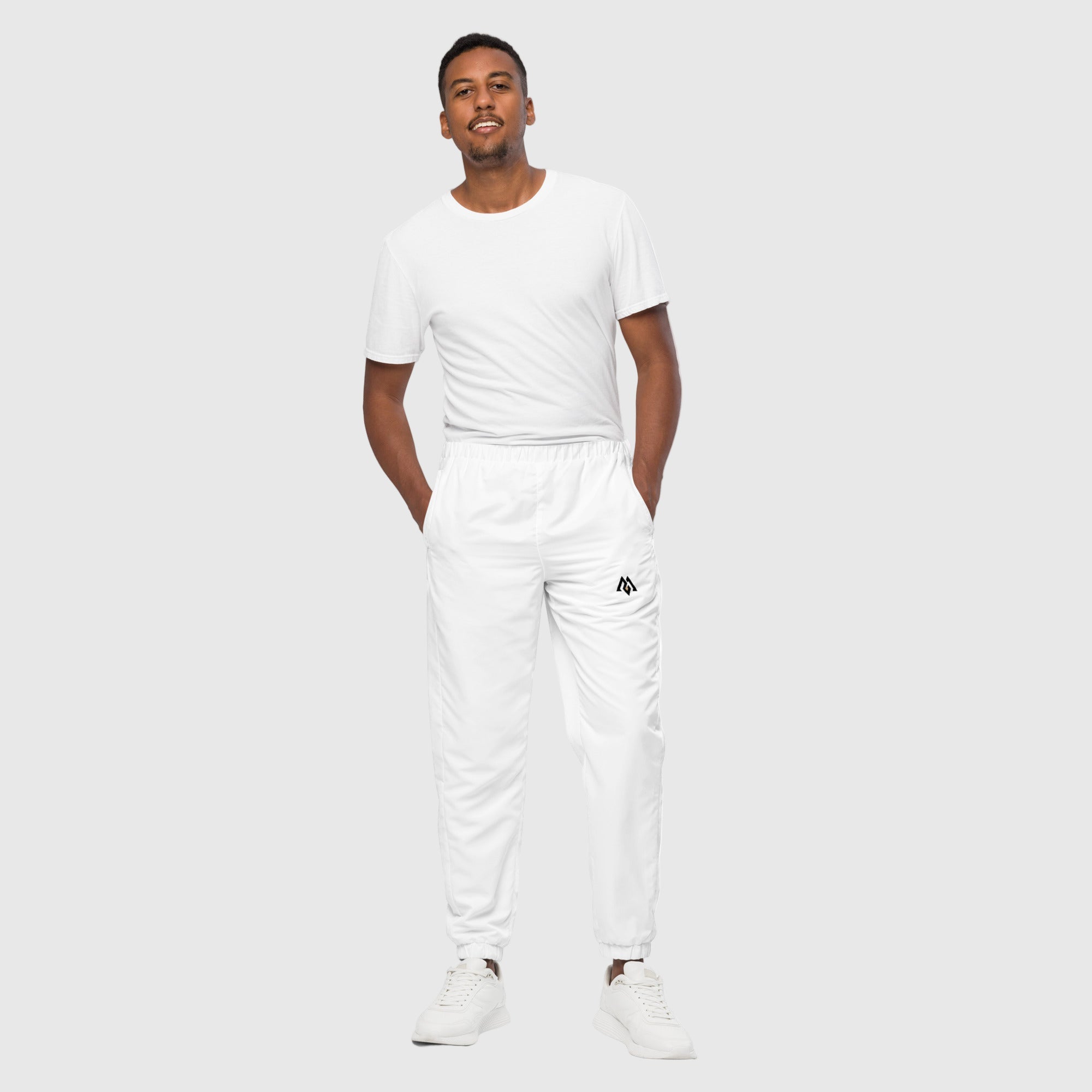 Model wearing ActiveAegis Unisex Track Pants in black – lightweight, tapered, and breathable activewear for gym and casual use