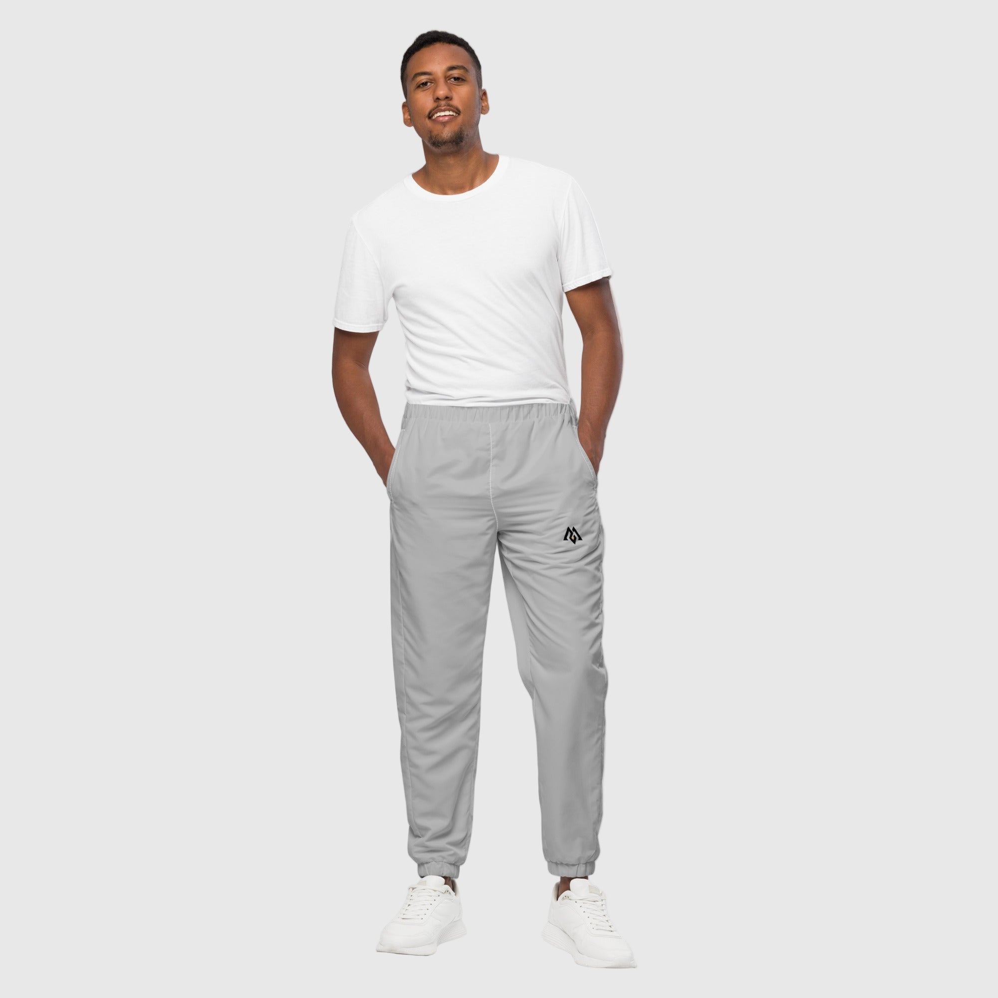 Model wearing ActiveAegis Unisex Track Pants in grey – tapered, breathable, and stretch-fit activewear for workouts and casual comfort
