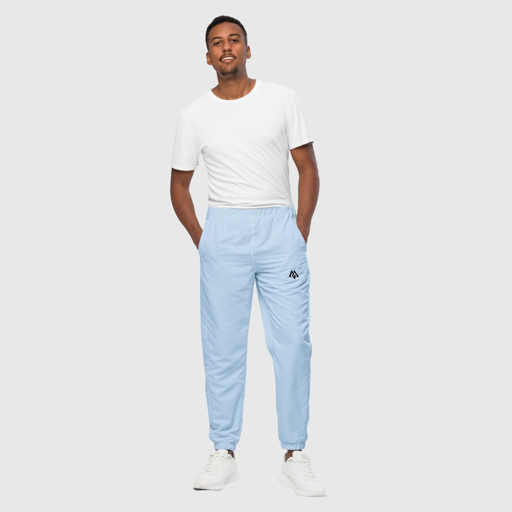 Model wearing ActiveAegis Unisex Track Pants in Pattens Blue – eco-friendly, stretch-fit, and breathable tapered joggers for gym and lifestyle comfort