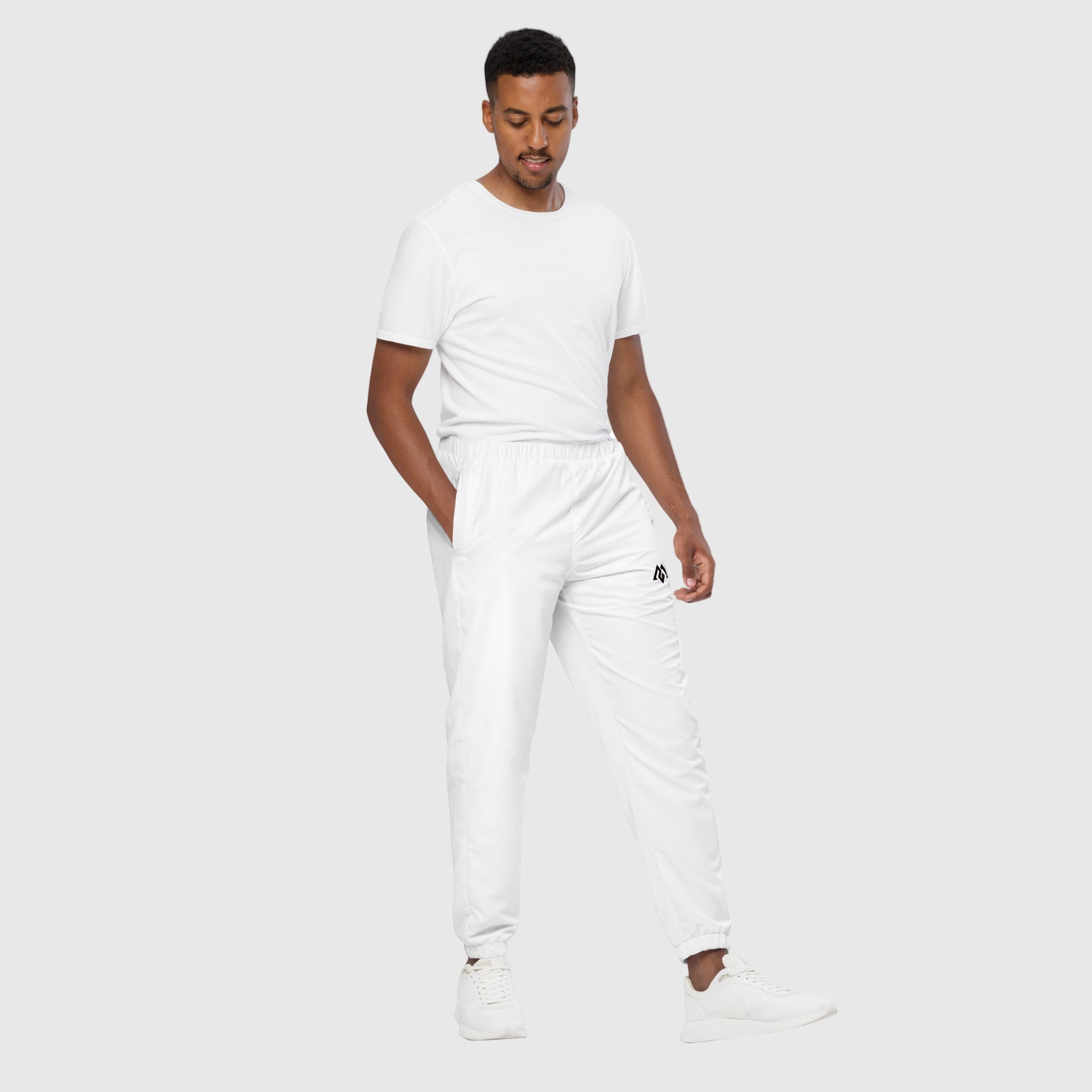 Model wearing ActiveAegis Unisex Track Pants in black – lightweight, tapered, and breathable activewear for gym and casual use