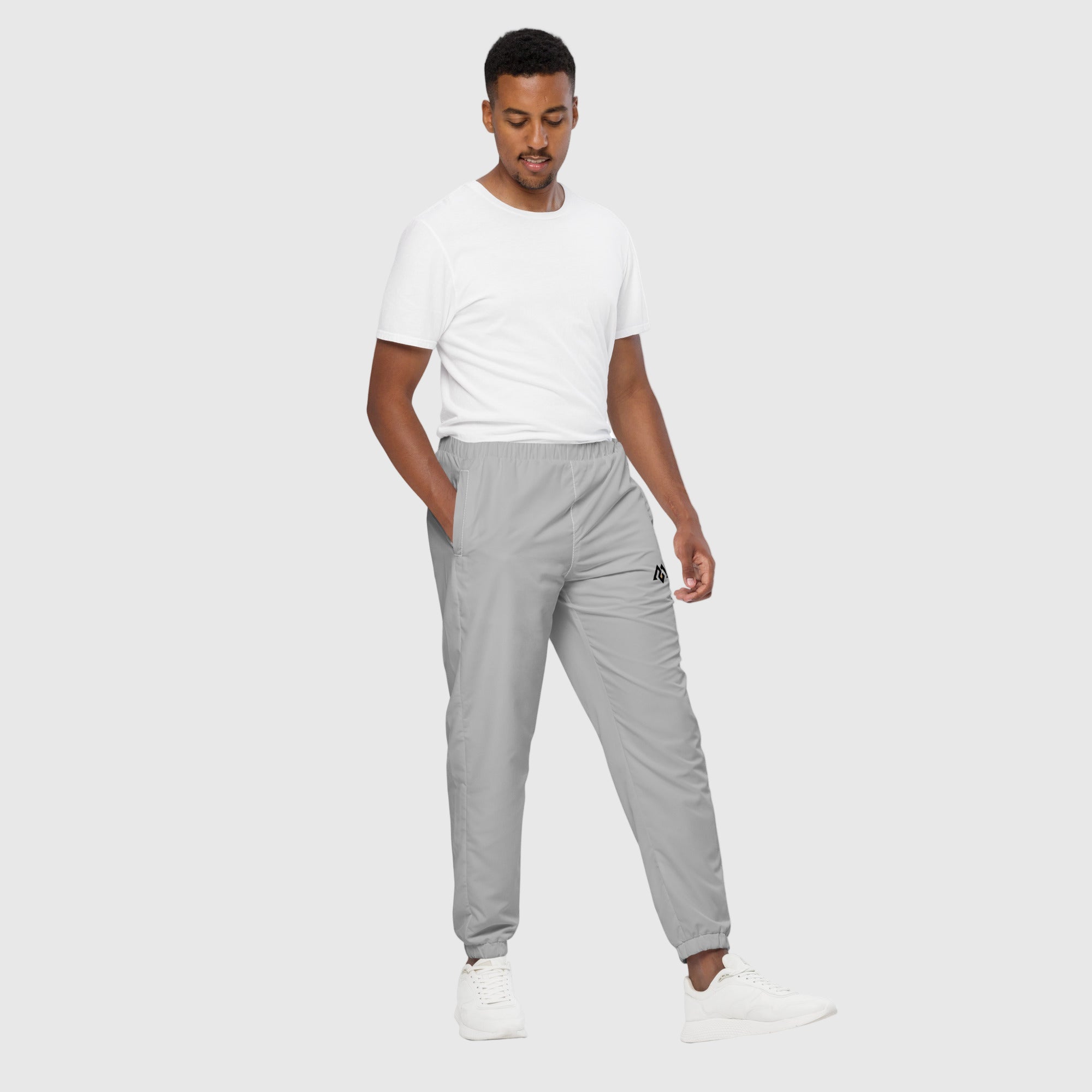 Model wearing ActiveAegis Unisex Track Pants in grey – tapered, breathable, and stretch-fit activewear for workouts and casual comfort