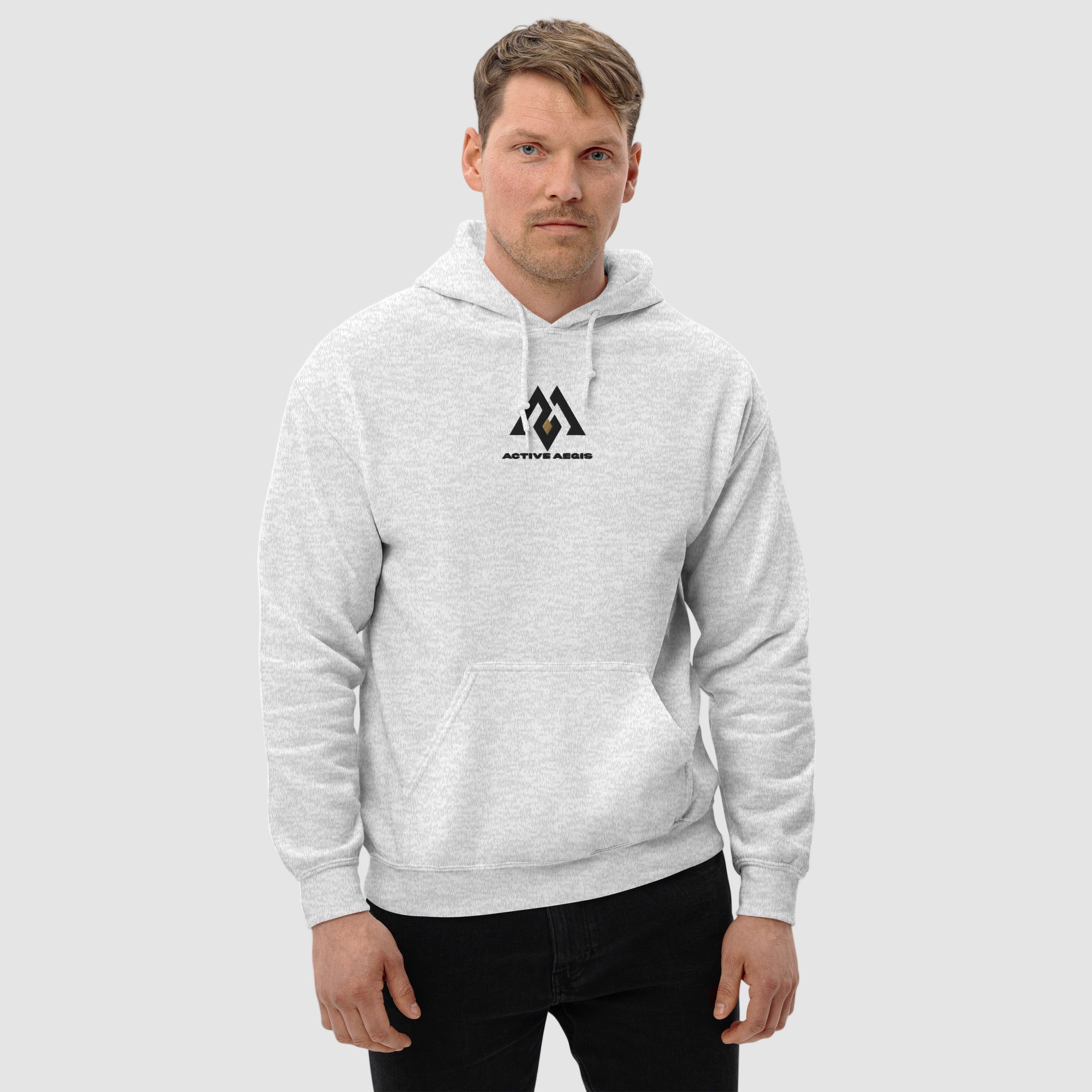 Man wearing a gray hoodie with a logo on a white background