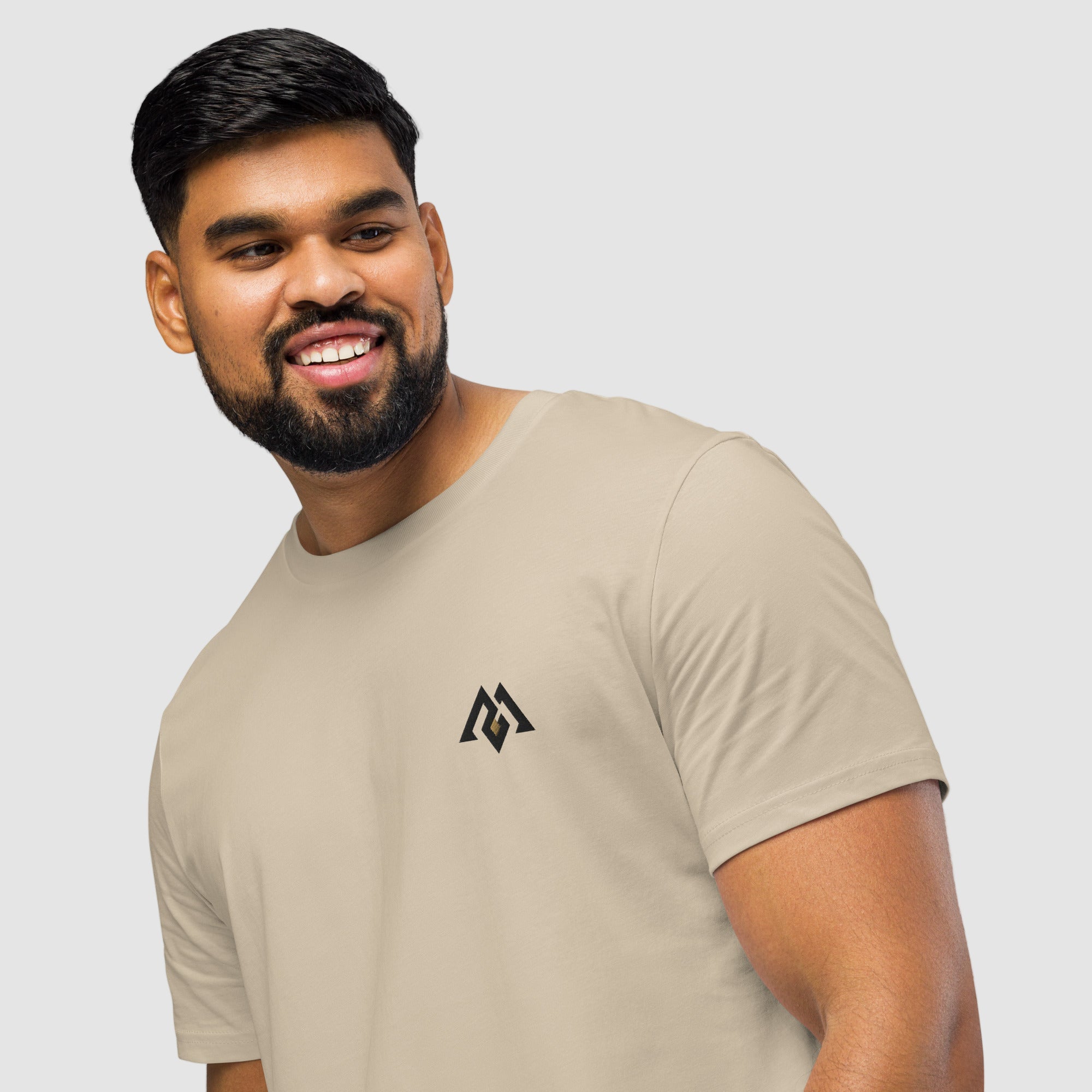 Model wearing ActiveAegis Unisex Organic Mid-Light T-Shirt in Desert Dust – soft 100% organic cotton tee in warm beige tone, sustainably made for active and casual wear