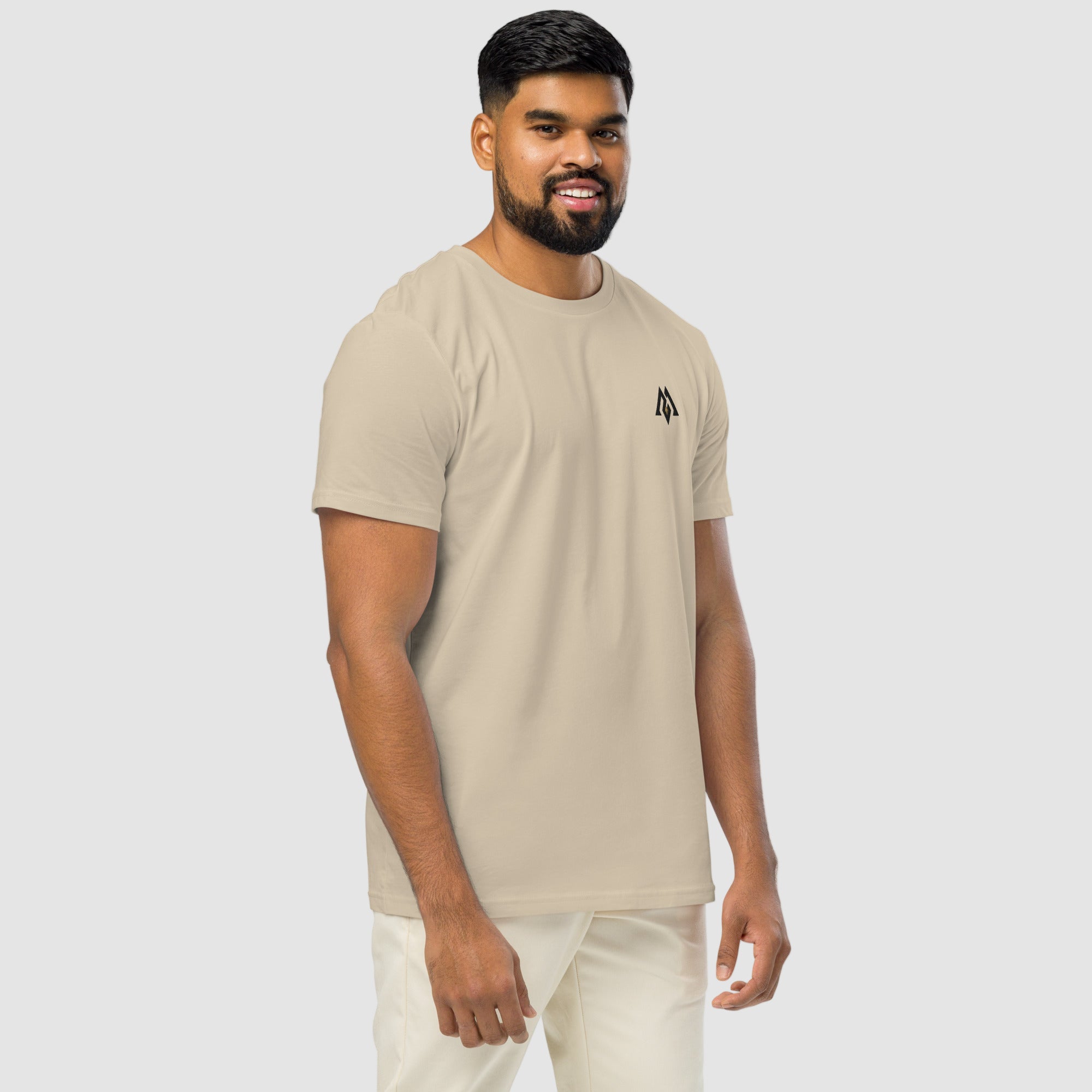 Model wearing ActiveAegis Unisex Organic Mid-Light T-Shirt in Desert Dust – soft 100% organic cotton tee in warm beige tone, sustainably made for active and casual wear